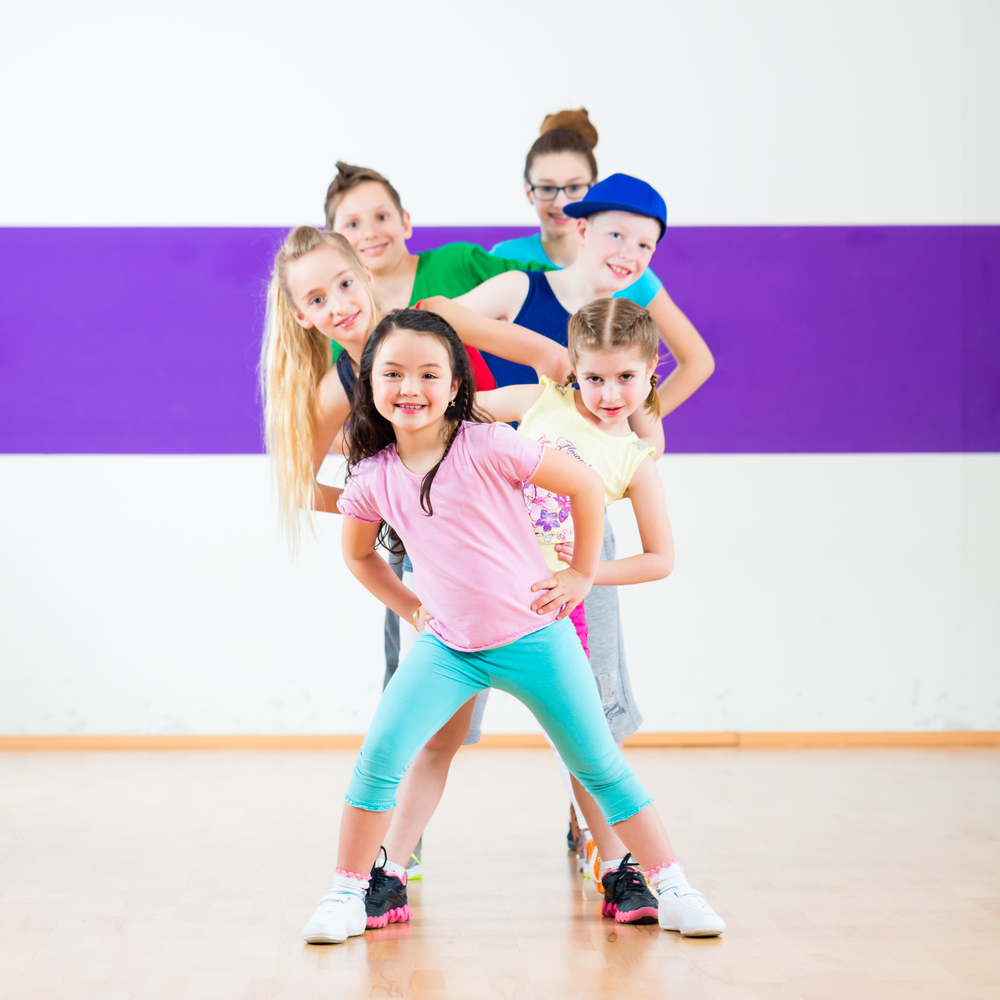 Children in zumba class dancing modern group choreography